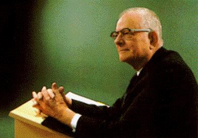 Photograph of W. Edwards Deming speaking at a lectern